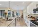 Modern kitchen with stainless steel appliances and a breakfast bar at 108 Wagon Place, Rotonda West, FL 33947