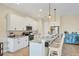 Modern kitchen with white cabinets, stainless steel appliances, and a breakfast bar with seating at 108 Wagon Place, Rotonda West, FL 33947