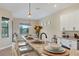 Bright kitchen with granite countertops, stainless steel appliances, and a view to the outside at 108 Wagon Place, Rotonda West, FL 33947