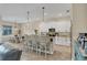 Open concept kitchen with breakfast bar, stainless steel appliances, and dining area at 108 Wagon Place, Rotonda West, FL 33947