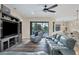 Spacious living room with comfortable seating, ceiling fan, and sliding glass doors to the outside at 108 Wagon Place, Rotonda West, FL 33947