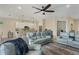 Inviting living room with modern furniture, ceiling fan, and open kitchen concept at 108 Wagon Place, Rotonda West, FL 33947