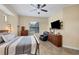 This spacious main bedroom has a ceiling fan, large window, and an oversized leather recliner at 108 Wagon Place, Rotonda West, FL 33947