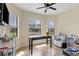 The office has three large windows and a ceiling fan at 108 Wagon Place, Rotonda West, FL 33947