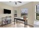 The office has three large windows, a ceiling fan, and storage shelves at 108 Wagon Place, Rotonda West, FL 33947