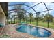Refreshing pool under a screened lanai, surrounded by a brick patio at 108 Wagon Place, Rotonda West, FL 33947