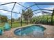 Lovely pool and lanai area with views of the surrounding nature at 108 Wagon Place, Rotonda West, FL 33947