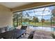 Stunning screened-in pool with an outdoor living space and backyard view at 108 Wagon Place, Rotonda West, FL 33947