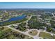 Expansive aerial view showcasing a beautiful home with a scenic lake in a peaceful neighborhood at 117 Cable Dr, Rotonda West, FL 33947