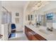 Bright bathroom features a double sink vanity, glass-enclosed shower, and tile flooring at 117 Cable Dr, Rotonda West, FL 33947