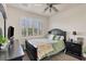 Cozy bedroom with a ceiling fan and plantation shutters at 117 Cable Dr, Rotonda West, FL 33947