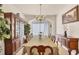 Elegant dining room with a large table, decorative chandelier, and classic furnishings at 117 Cable Dr, Rotonda West, FL 33947