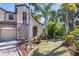 Charming home featuring a stone accent wall, arched entryway, and well-manicured landscaping at 117 Cable Dr, Rotonda West, FL 33947