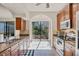 Bright kitchen with stainless steel appliances, granite countertops, and tiled flooring at 117 Cable Dr, Rotonda West, FL 33947