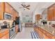 Open kitchen with wood cabinets, granite countertops and stainless steel appliances at 117 Cable Dr, Rotonda West, FL 33947