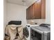 Functional laundry room with washer, dryer, and cabinetry at 117 Cable Dr, Rotonda West, FL 33947