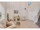 Elegant living room featuring high ceilings, tiled flooring, and a staircase at 117 Cable Dr, Rotonda West, FL 33947