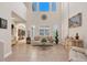 Light-filled living room with tall ceilings, tile floors, and a cozy seating area at 117 Cable Dr, Rotonda West, FL 33947