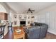 Open-concept living room with a fireplace, custom shelving and a leather couch at 117 Cable Dr, Rotonda West, FL 33947