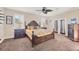 Spacious main bedroom with a four-poster bed, shuttered windows and elegant furnishings at 117 Cable Dr, Rotonda West, FL 33947