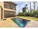 An outdoor pool offers a refreshing retreat complemented by lush landscaping and a screened-in patio for relaxed outdoor living at 117 Cable Dr, Rotonda West, FL 33947
