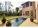 Backyard pool surrounded by lush landscaping, showcasing a serene outdoor space at 117 Cable Dr, Rotonda West, FL 33947