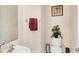 Clean powder room featuring a sleek sink, toilet, and stylish decor at 117 Cable Dr, Rotonda West, FL 33947