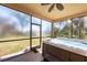 Relaxing screened porch featuring a modern hot tub and scenic backyard views at 117 Cable Dr, Rotonda West, FL 33947