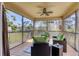 Inviting screened porch with comfortable seating and serene views of lush greenery at 117 Cable Dr, Rotonda West, FL 33947