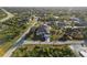 Beautiful aerial view of a well-manicured home with lush landscaping and a long driveway in a desirable neighborhood at 13575 Chenille Dr, Port Charlotte, FL 33981