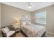 Comfortable bedroom showcasing neutral tones, a cozy bed, and stylish furnishings at 13575 Chenille Dr, Port Charlotte, FL 33981
