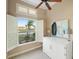 Bright bedroom featuring white plantation shutters, modern decor, and plenty of natural light at 13575 Chenille Dr, Port Charlotte, FL 33981