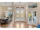 A spacious tiled foyer features a double-door entryway, elegant chandelier, and high ceilings at 13575 Chenille Dr, Port Charlotte, FL 33981