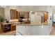 Open kitchen features granite countertops, wood cabinets, and modern appliances at 13575 Chenille Dr, Port Charlotte, FL 33981