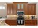 Modern kitchen featuring stainless steel appliances, granite counters, and wood cabinetry at 13575 Chenille Dr, Port Charlotte, FL 33981