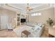 Spacious living room with built-in shelving, ceiling fan, and comfortable seating at 13575 Chenille Dr, Port Charlotte, FL 33981
