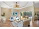An inviting living room features tiled floors, modern seating, and an open doorway to the lanai at 13575 Chenille Dr, Port Charlotte, FL 33981
