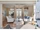 A bright living room features an airy layout, stylish furnishings, and plenty of natural light at 13575 Chenille Dr, Port Charlotte, FL 33981