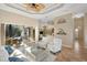 A welcoming living room features tiled floors, tray ceilings, and seamless access to the outdoor area at 13575 Chenille Dr, Port Charlotte, FL 33981