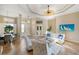 A modern living room features tiled floors, stylish seating, and a decorative tray ceiling at 13575 Chenille Dr, Port Charlotte, FL 33981