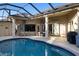 Inviting in-ground pool surrounded by a spacious patio with an outdoor seating area, perfect for relaxation at 13575 Chenille Dr, Port Charlotte, FL 33981