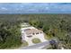 Attractive aerial view of house with long driveway and lush trees around the property at 1600 Thomas St, Englewood, FL 34223