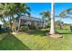 Lush backyard with screened-in porch with private pool and tropical landscaping at 214 W Pine Valley Ln, Rotonda West, FL 33947