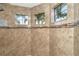 Bathroom featuring tiled walls, three windows, and modern fixtures at 214 W Pine Valley Ln, Rotonda West, FL 33947