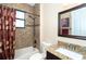 Bathroom featuring a shower/tub combo, and granite countertops at 214 W Pine Valley Ln, Rotonda West, FL 33947