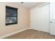 Bedroom featuring hardwood floors, a large window with blinds, and double door closet at 214 W Pine Valley Ln, Rotonda West, FL 33947