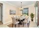 Modern dining room with a chandelier, a large window, and a table that seats six at 214 W Pine Valley Ln, Rotonda West, FL 33947