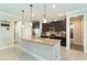 Bright, open kitchen with a granite island, stainless steel appliances, and dark wood cabinetry at 214 W Pine Valley Ln, Rotonda West, FL 33947