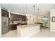Open kitchen with granite countertops, stainless steel appliances, and an island with bar seating at 214 W Pine Valley Ln, Rotonda West, FL 33947
