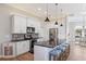 Well-equipped kitchen with stainless steel appliances, a breakfast bar, and stylish pendant lighting at 497 Rotonda Cir, Rotonda West, FL 33947
